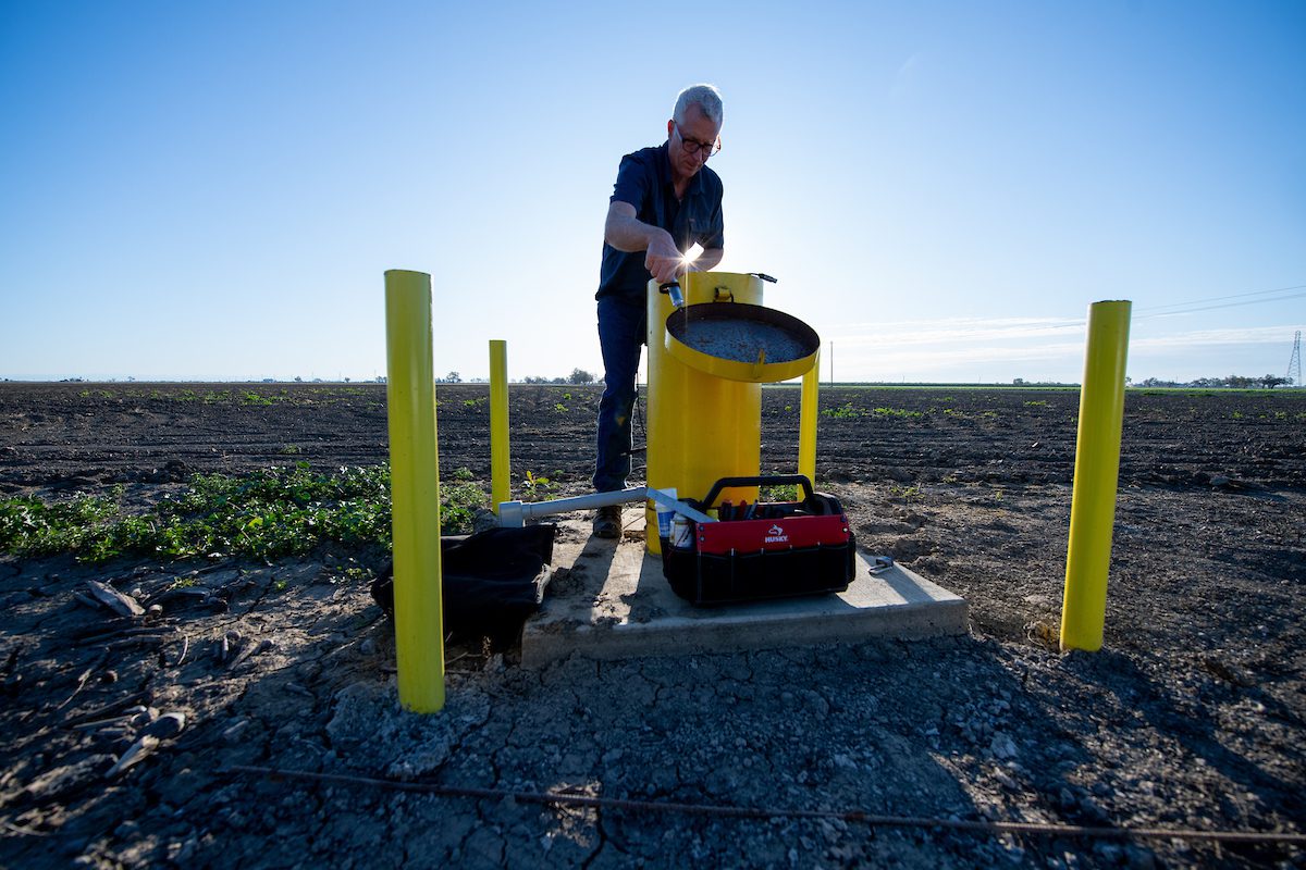 An engineer visits a groundwater monitor in California.