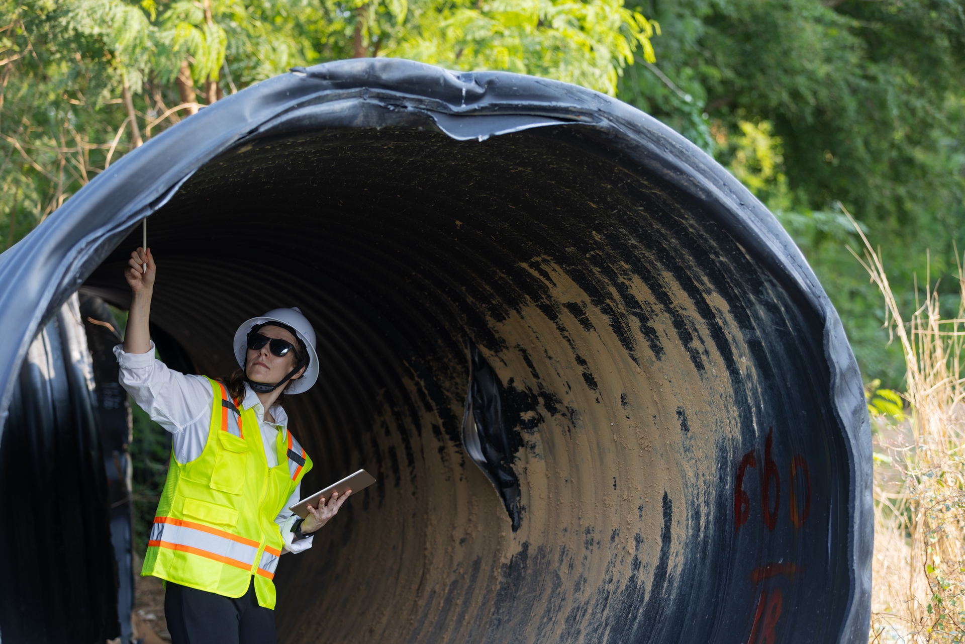 Woman inspecting pipeline