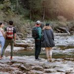 Outdoor recreation: 2 couples hike along a river