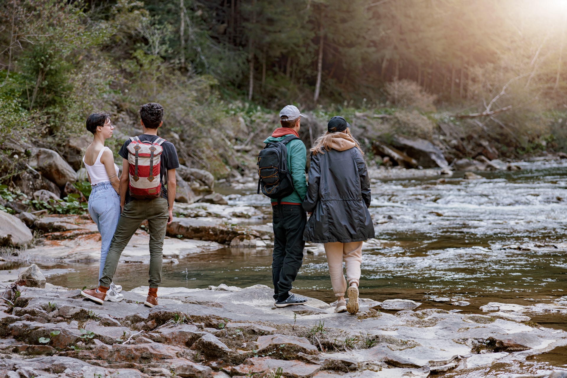 Outdoor recreation: 2 couples hike along a river