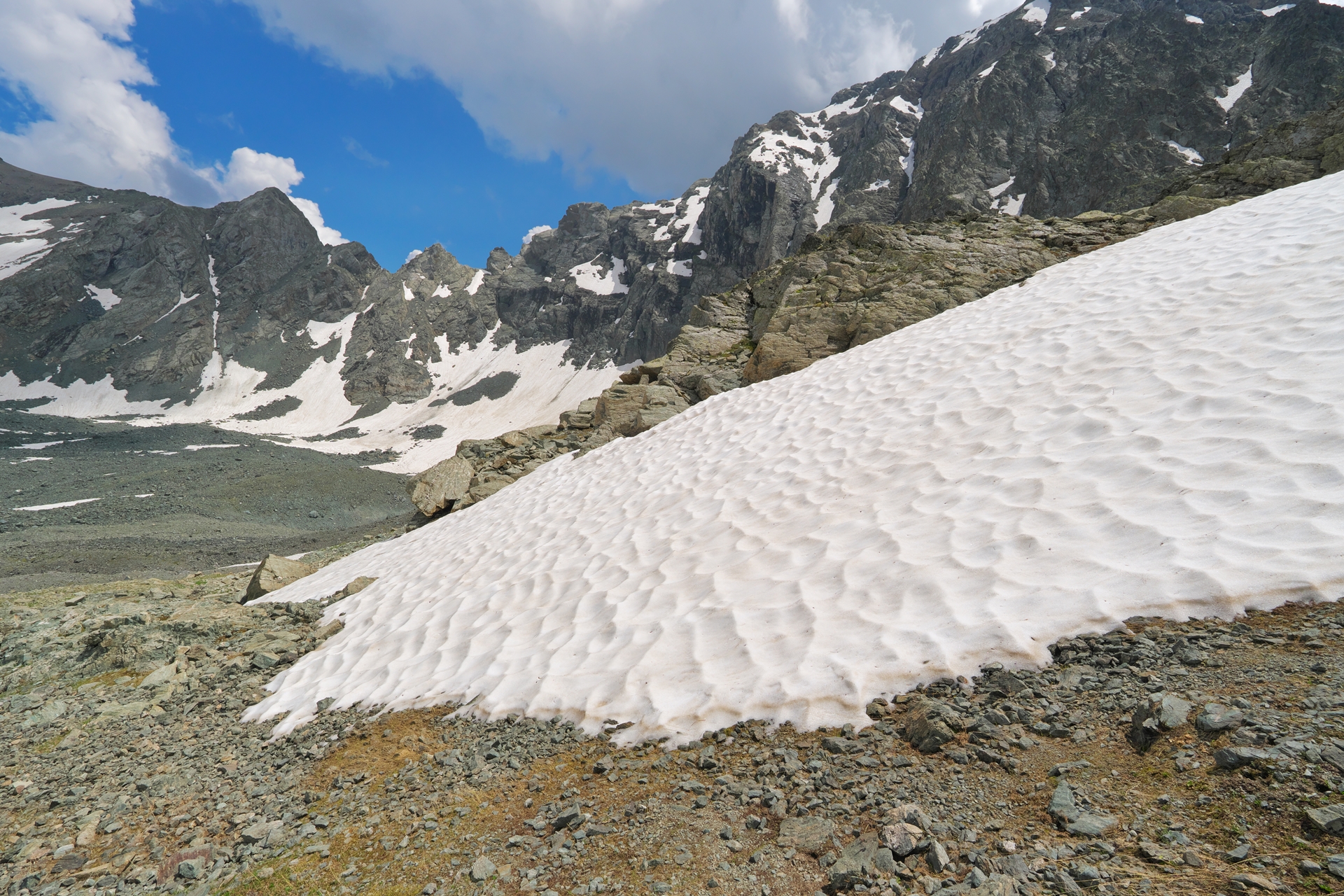 A mountain with patchy snow, representing snow drought