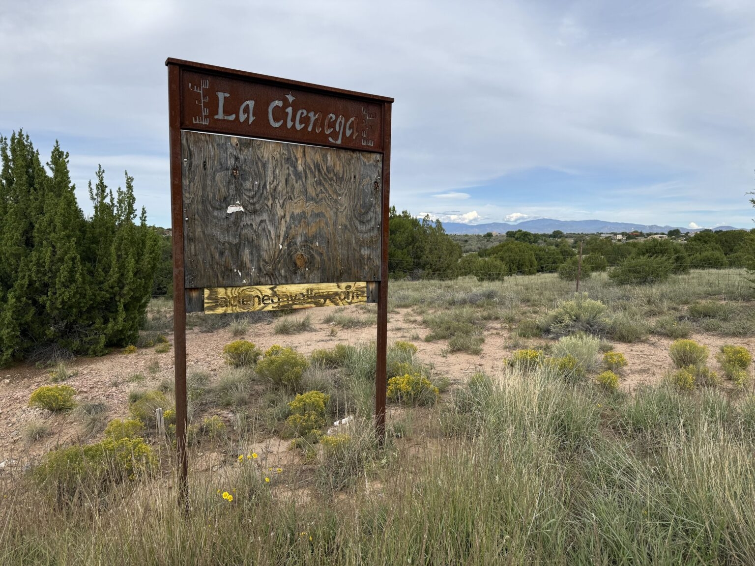 Dilapidated sign in rural Santa Fe County (Source NM)